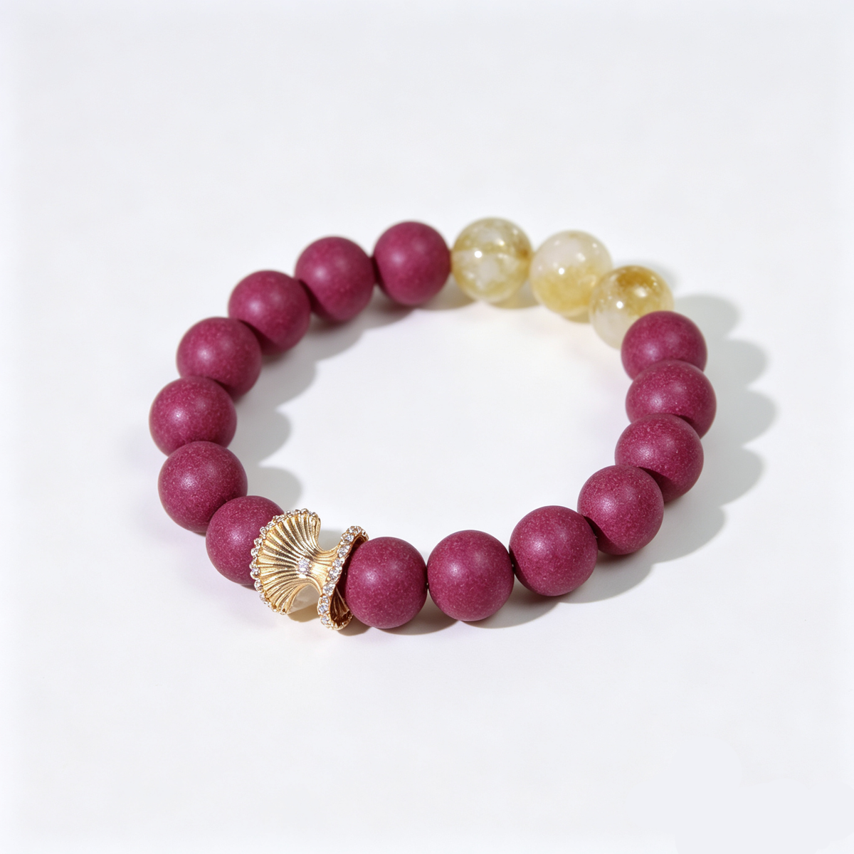 BEYUL Fire Element fuchsia incense bead bracelet with citrine and gold leaf charm — handmade pressed botanical beads, front view